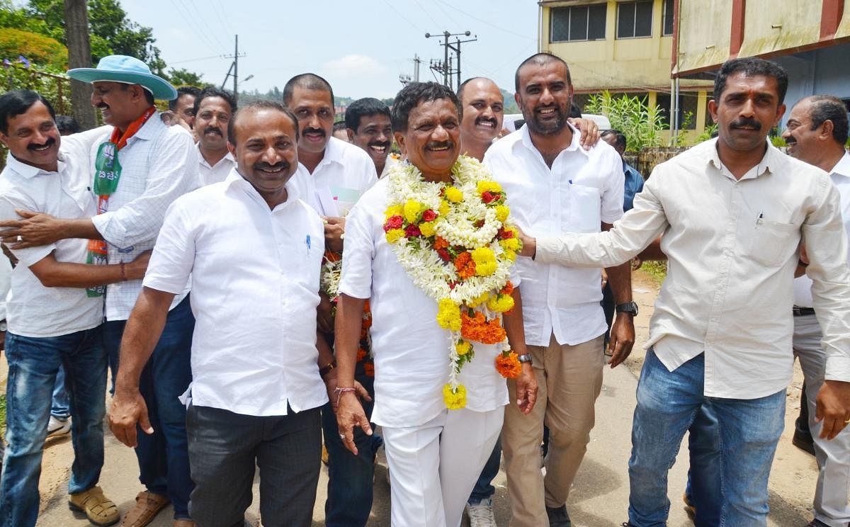 Winning candidate K G Bopaiah from BJP being greeted by the partyworkers in Madikeri on Tuesday.