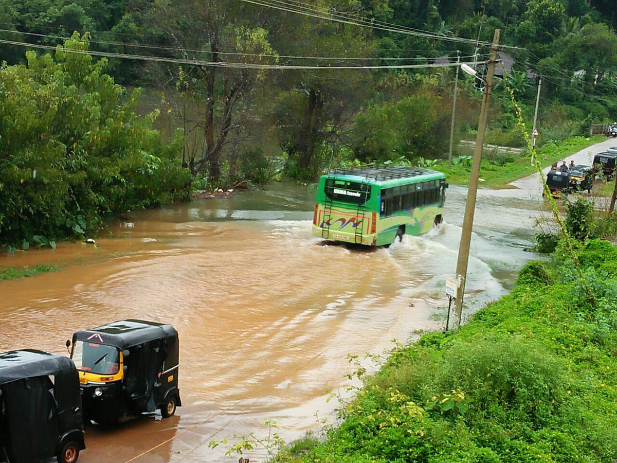 Vehicles wading through the flooded Napoklu-Bhagamandala road.