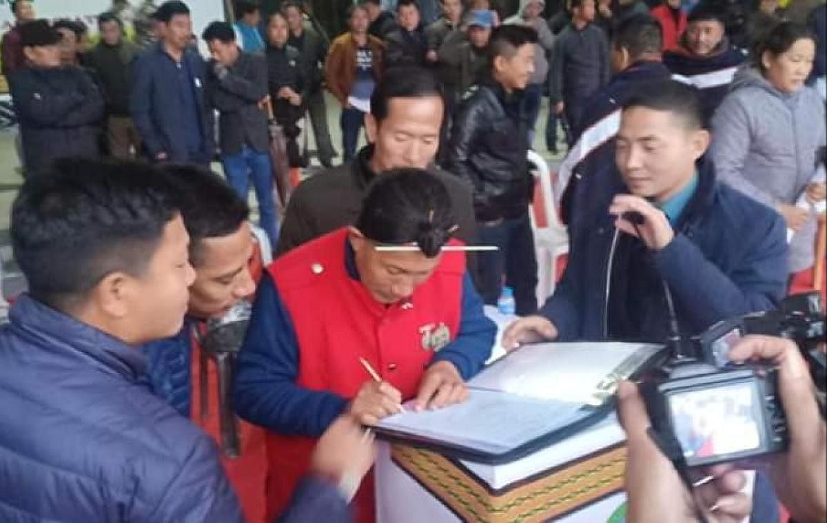 An open-air public meeting held on Sunday in the Dree festival ground at Ziro saw two candidates, one from BJP and one Congress contesting in the 17th Ziro-Hapoli Assembly constituency (Scheduled Tribe) sign the MoU with the Apatani Youth Association (AYA). Photo by D Tagey, Ziro. 