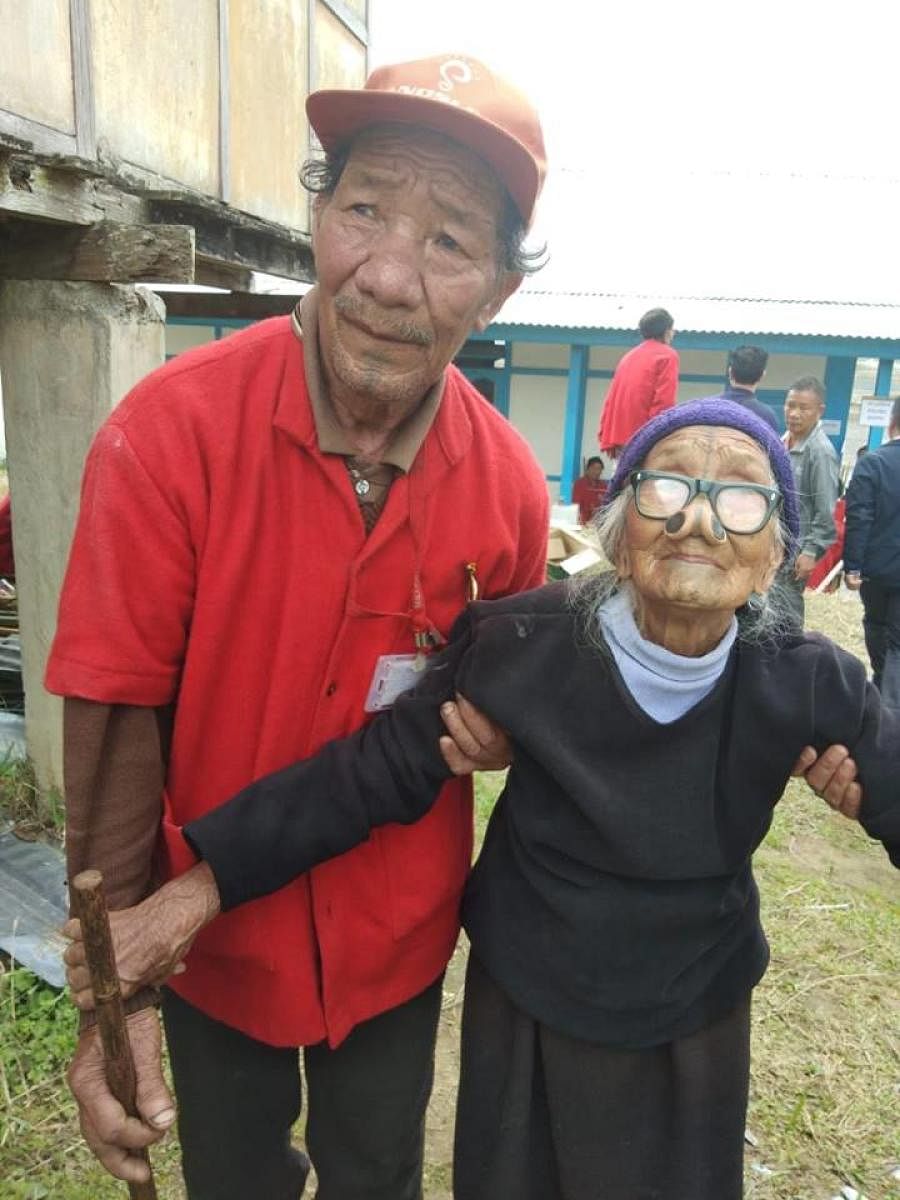 An elderly voter in Ziro in Arunachal Pradesh on her way to polling booth with her son on Thursday.