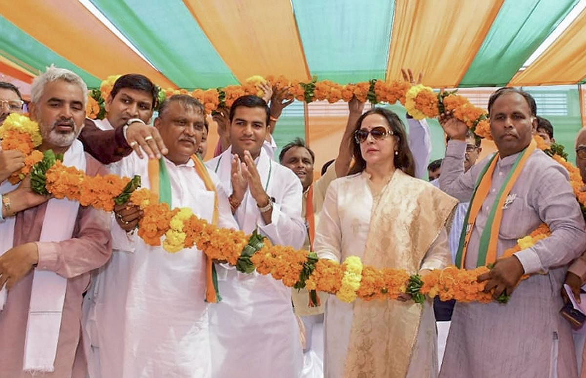 BJP MP from Mathura Hema Malini being garlanded during an election campaign rally in support of party candidate Jagdish Nayar, at Hodal in Palwal district of Haryana onFriday. (PTI Photo)