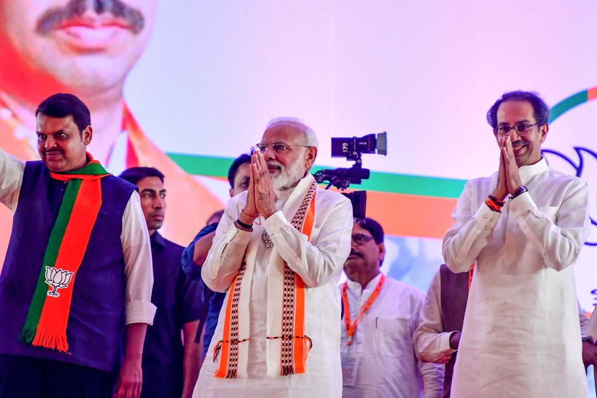 Prime Minister Narendra Modi gestures along with Shiv Sena Chief Uddhav Thackeray and Chief Minister of the state Devendra Fadnavis as they attend a public rally in the run up to the Maharashtra state assembly elections, in Mumbai on October 18, 2019. (AF