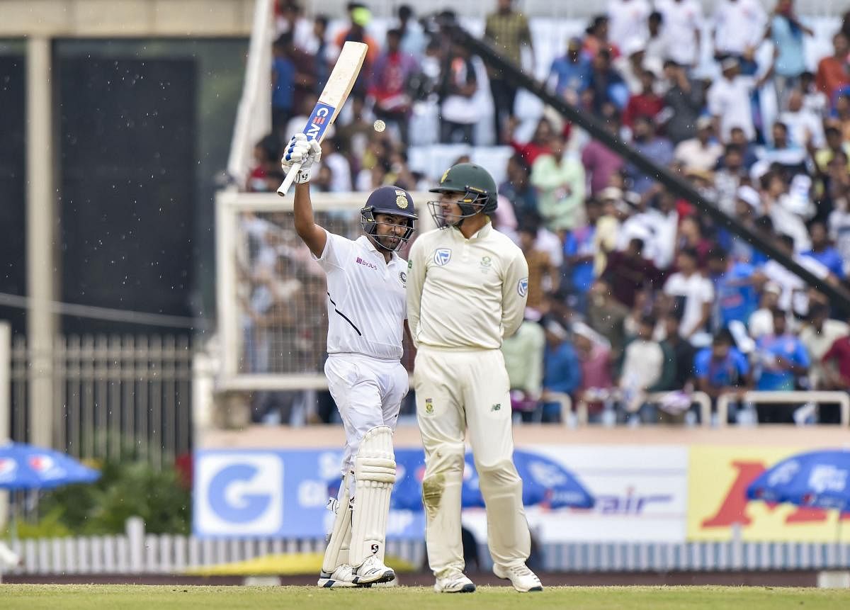 Indian cricketer Rohit Sharma celebrates after scoring 100 runs during the 3rd Test match between India and South Africa at JSCA Stadium in Ranchi. PTI