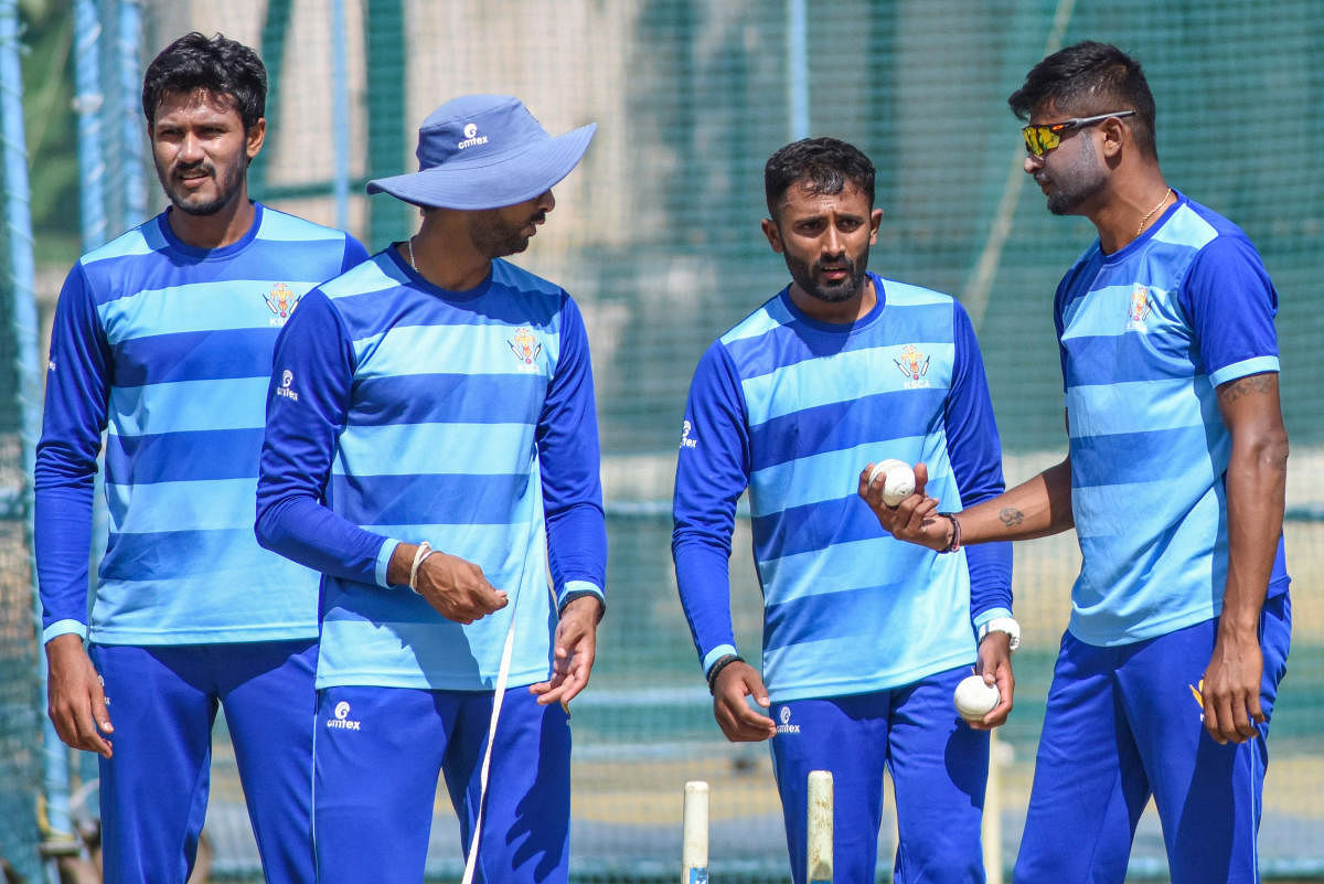 Karnataka pacer V Koushik, bowling coach S Arvind, spinners Shreyas Gopal and K Gowtham(from left) at a practice session in Bengaluru on Saturday. DH PHOTO/ S K DINESH
