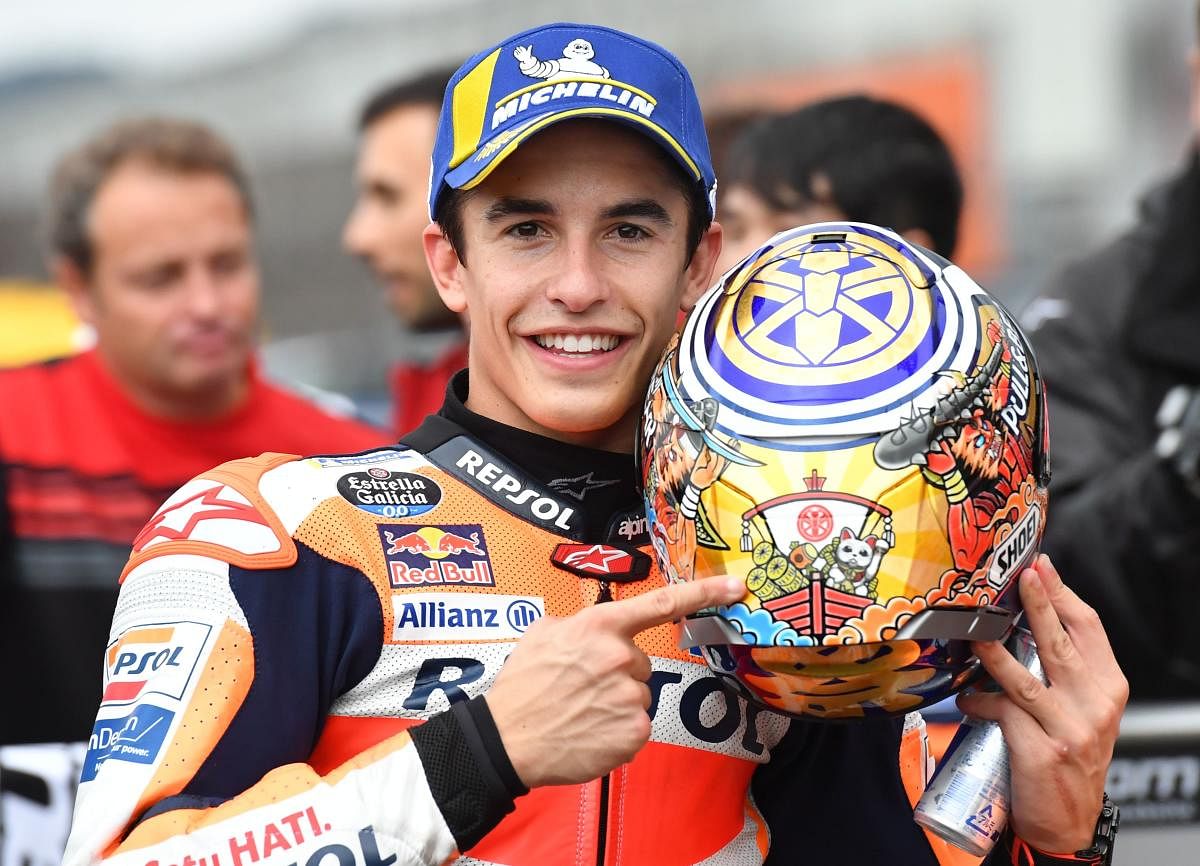 Repsol Honda Team rider Marc Marquez of Spain celebrates his pole position at the parc ferme after the MotoGP qualifying session of the Japanese motorcyle Grand Prix at the Twin Ring Motegi circuit in Motegi, Tochigi prefecture on October 19, 2019. Photo/AFP