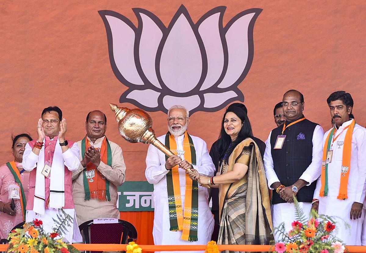 Prime Minister Narendra Modi being presented a mace during an election campaign rally ahead of Assembly polls in Haryana. PTI