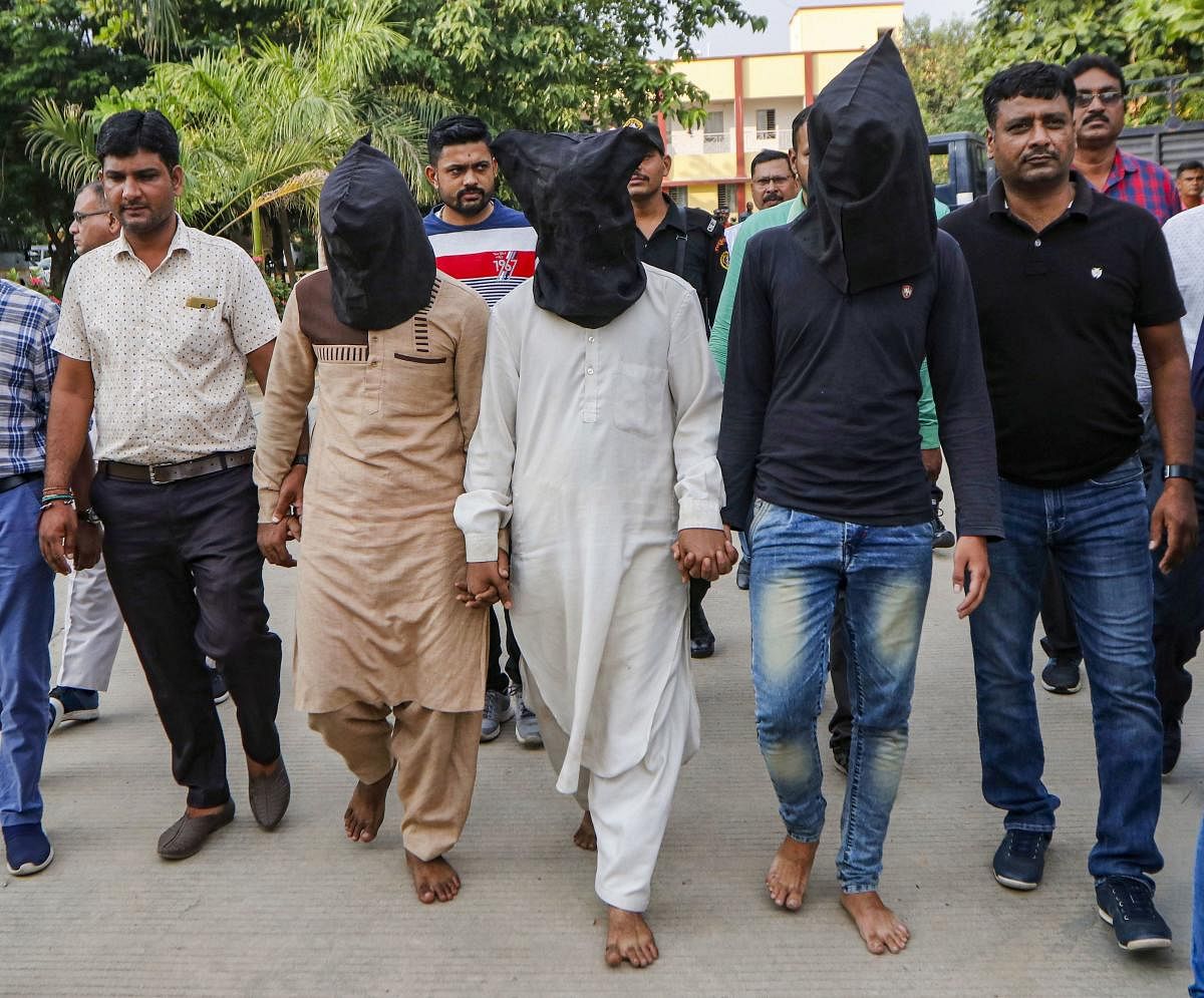 Gujarat Anti-terrorist squad (ATS) officers produce and hand over three suspect related to the murder of Hindu Samaj Party founder-leader Kamlesh Tiwari to UP Police, in Ahmedabad, Saturday, Oct. 19, 2019. (PTI Photo)