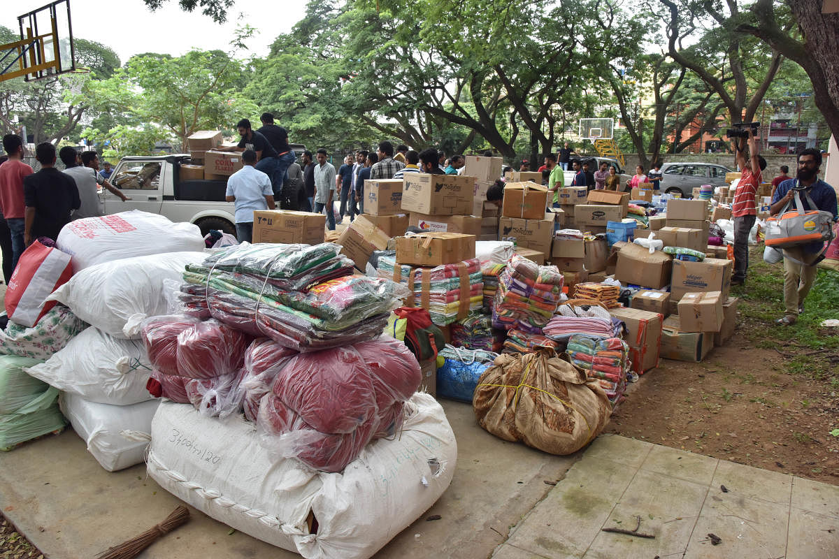 Volunteers sorting out relief material at the Kodava Samaja in Bengaluru on Saturday. DH Photo/Janardhan B K