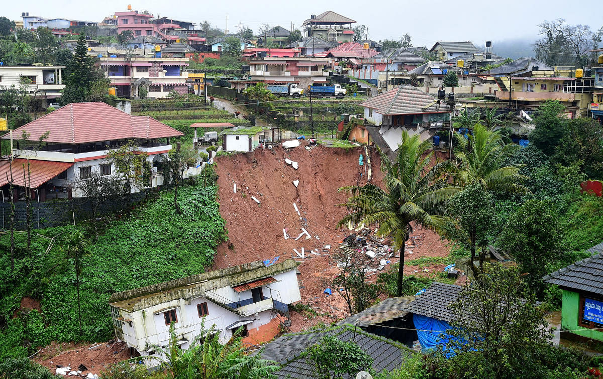 A concrete house has slipped after mud caved in following heavy rain in Madikeri. DH PHOTO