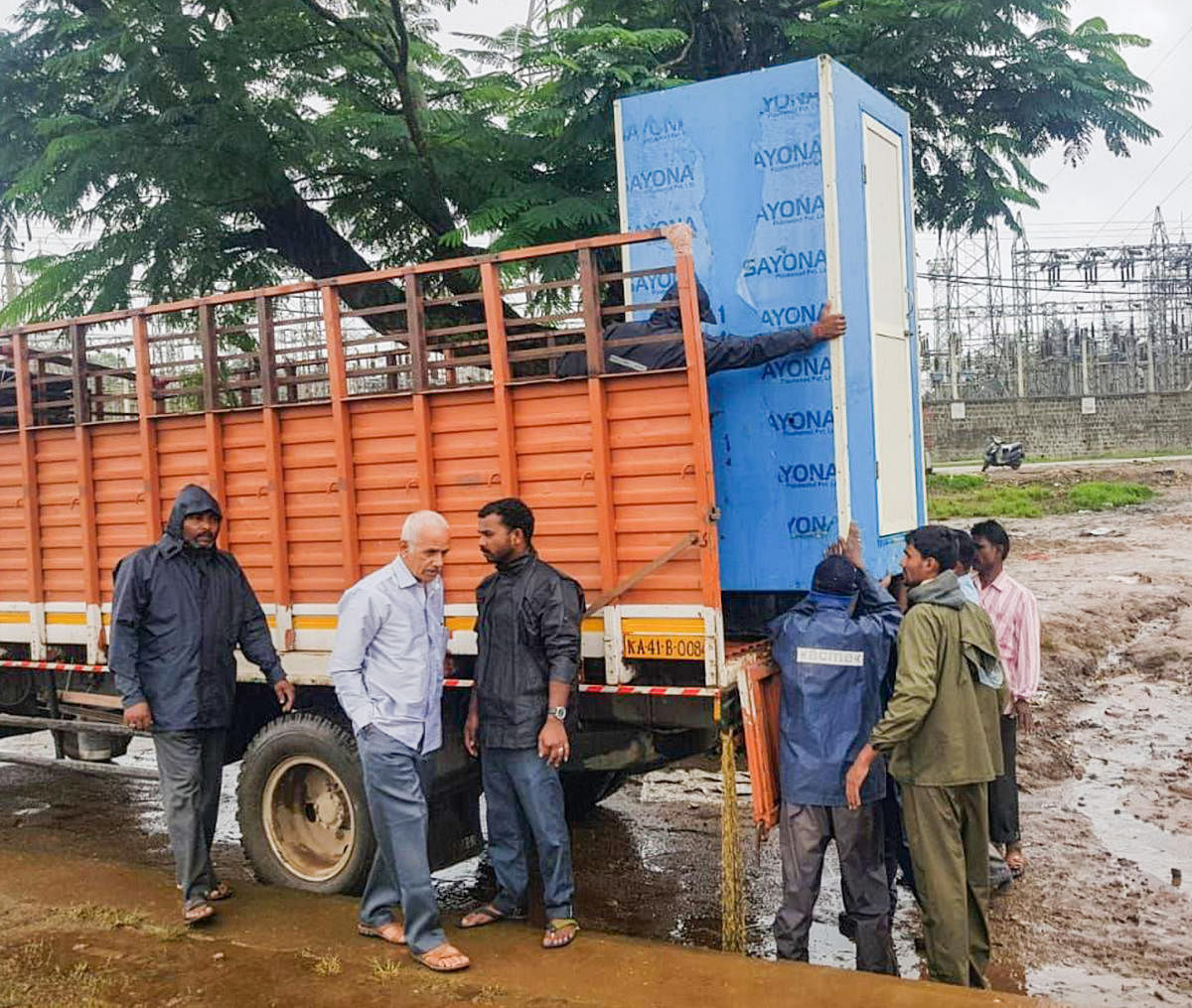 BBMP workers transporting mobile toilets to the flood-hit Kodagu district on Sunday.
