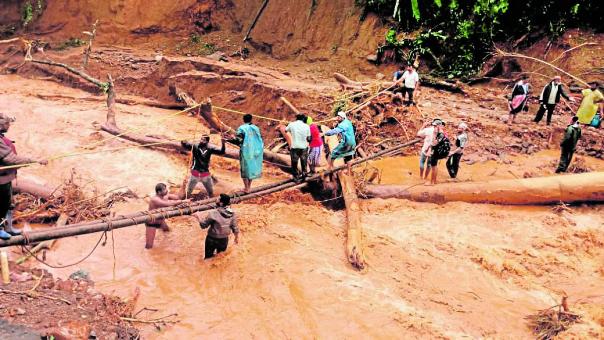 Victims being rescued using a makeshift bridge from the hilly ranges in Kodagu district.