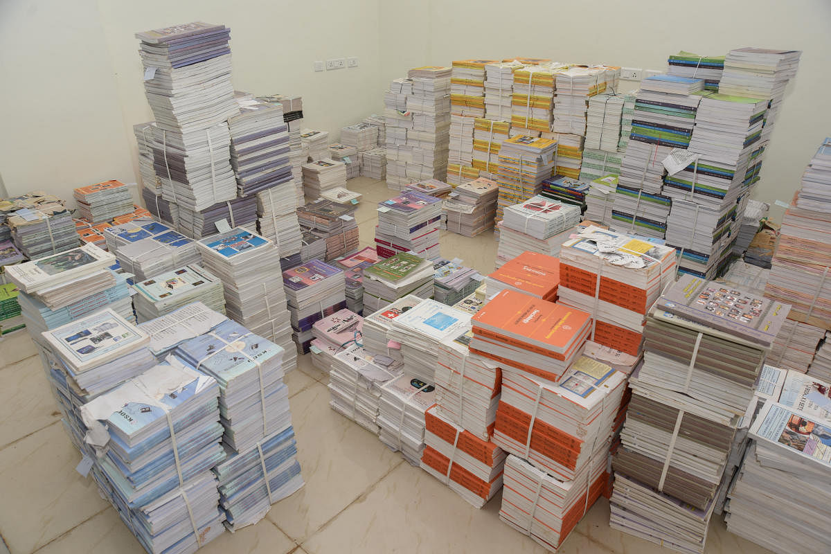 Karnataka State Open University convocation hall in Mysuru; books stacked in a room at a KSOU centre. DH photos/ Savitha B R, Anup R Tippeswamy