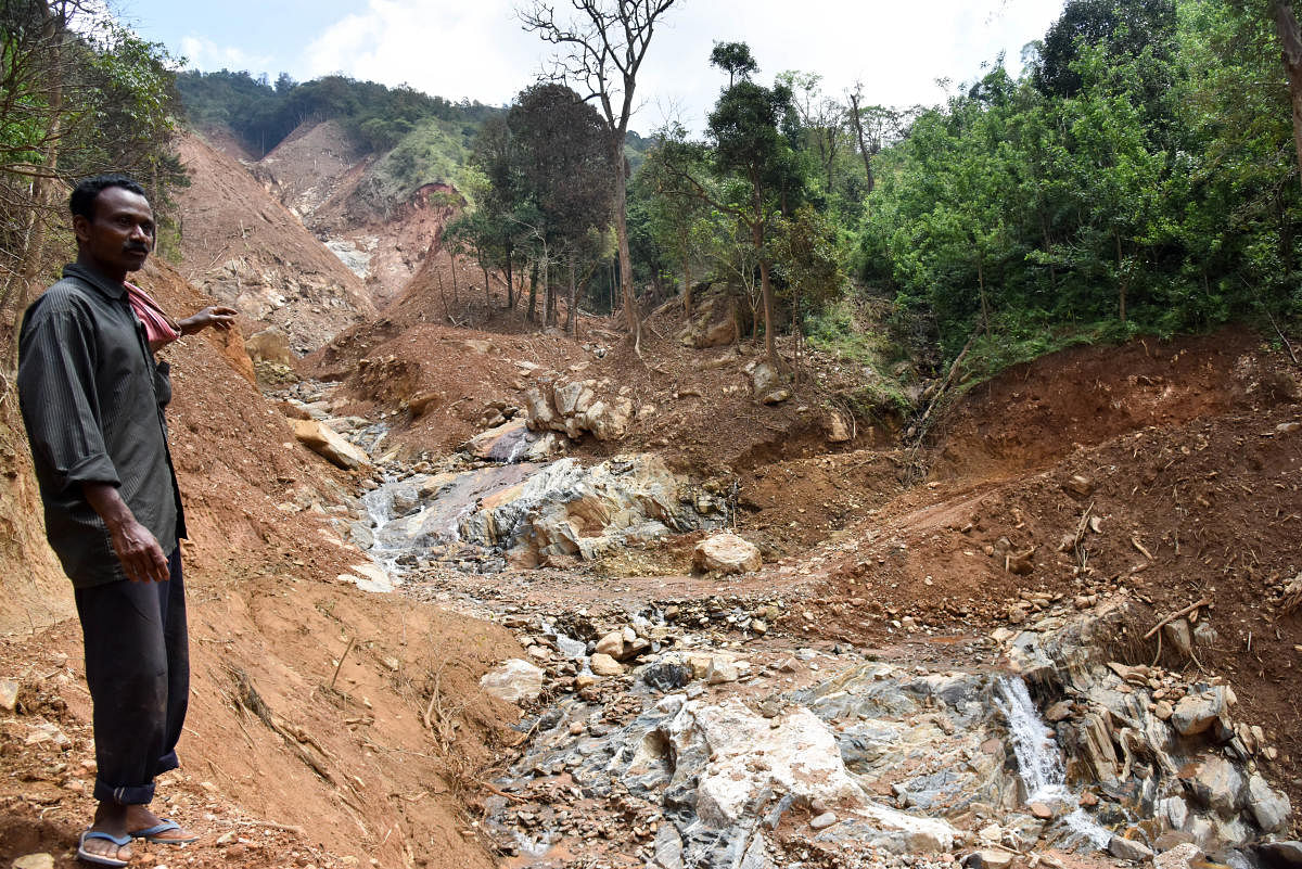 K E Krishnappa Nayaka near his farm after the recent landslides at Second Monnangeri in Kodagu. DH Photo/B H Shivakumar