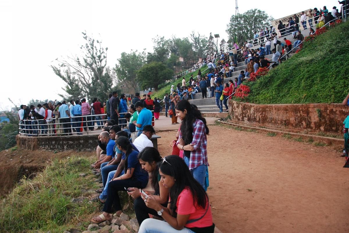 Tourists at Raja Seat in Madikeri.