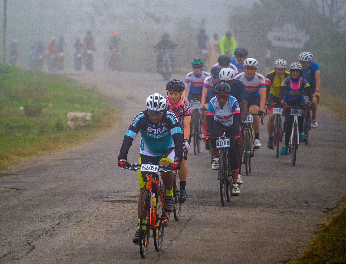 Cyclists who are participating in the ‘Tour of Nilgiris’ pass through Kodagu on Monday.