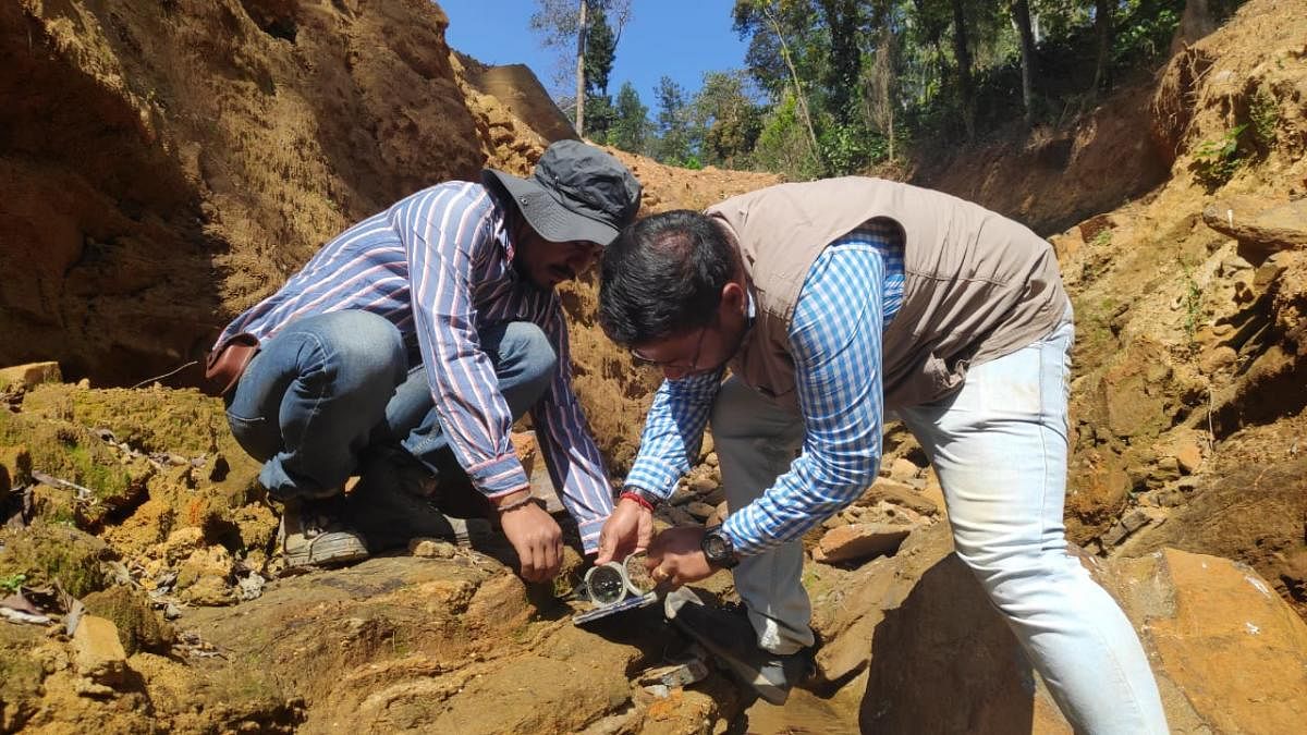 Scientists from the Geological Survey of India conduct a study at the site of a landslide in Kodagu.