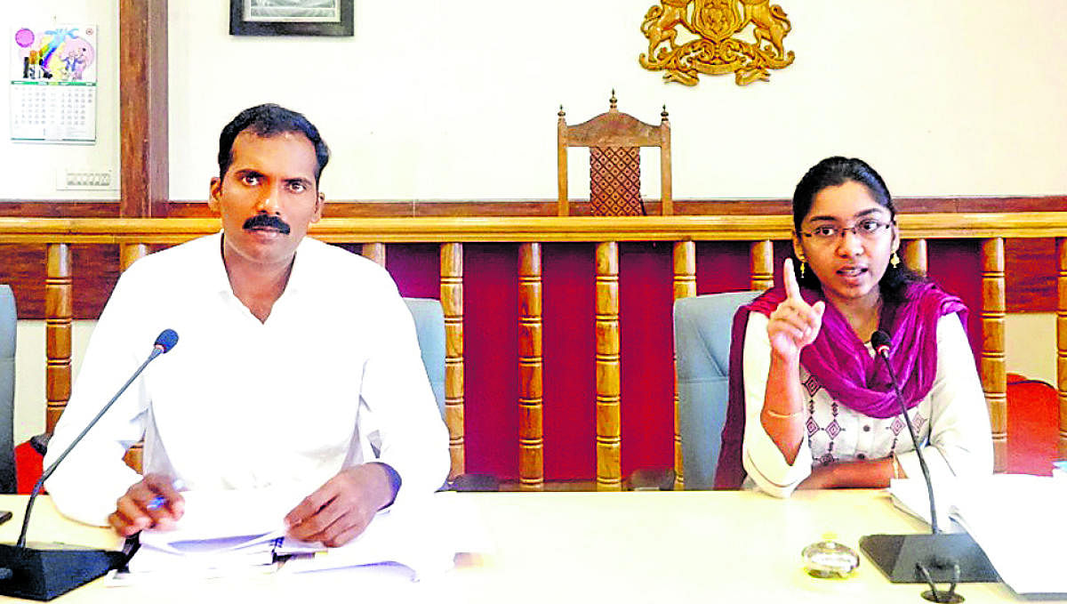 Zilla Panchayat CEO K Lakshmi Priya speaks during the meeting of election nodal officers at the DC's office hall on Monday. Kodagu Additional Deputy Commissioner T Yogesh looks on.