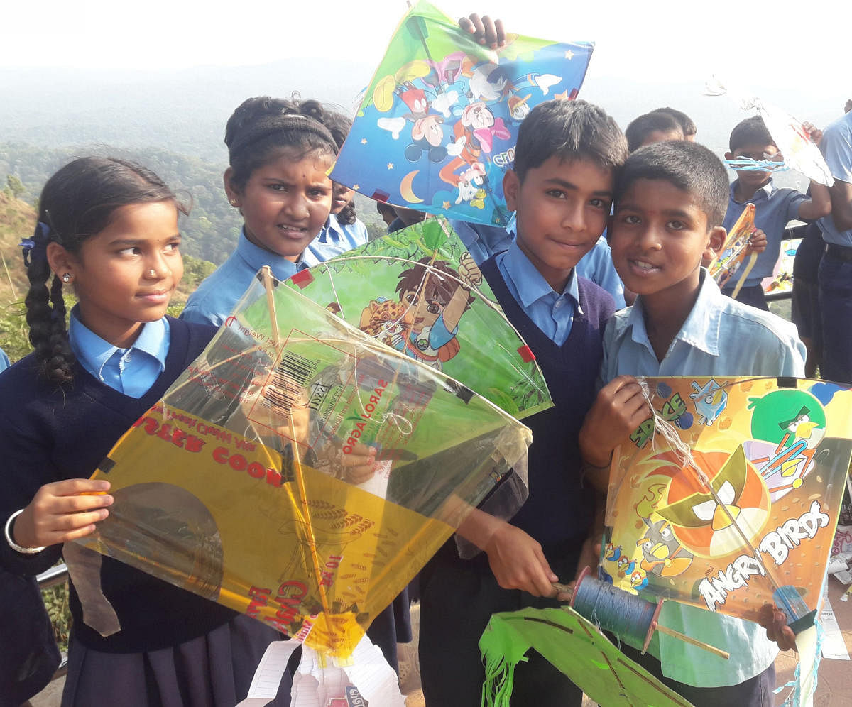 Children take part in a kite festival on the theme of voting in Madikeri.