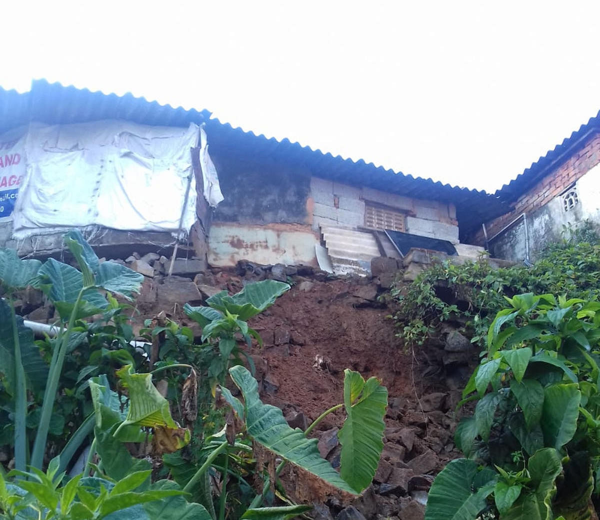 One of the three houses damaged due to heavy rains at Virajpet. DH Photo