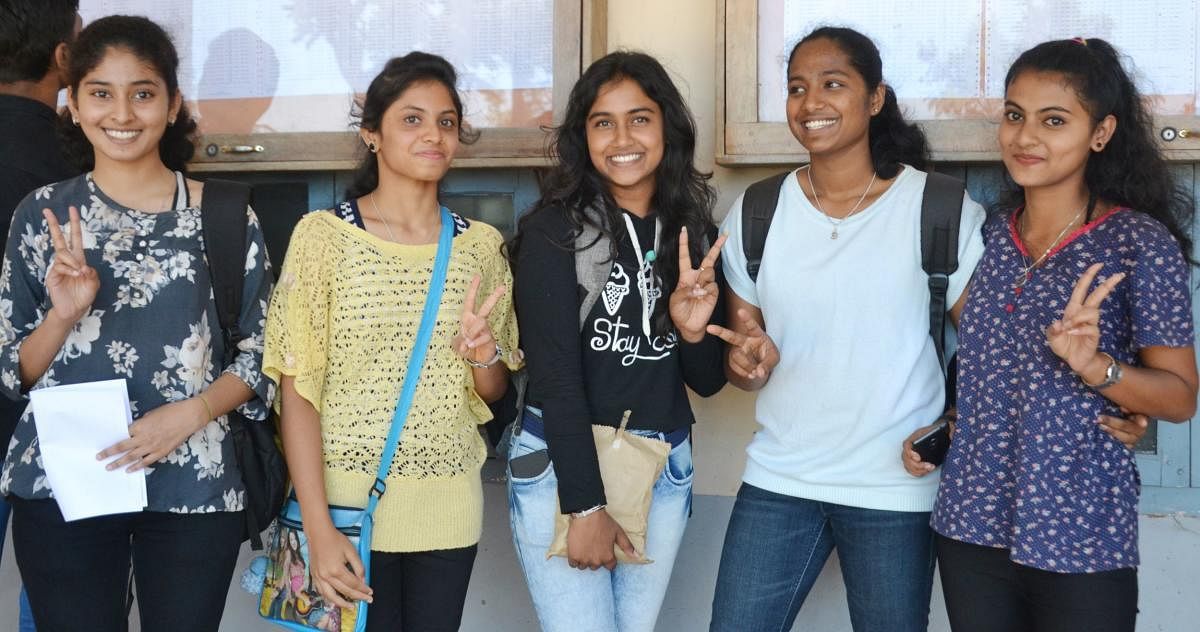 Students rejoice after checking their results in the II PU examinations in their college on Tuesday.