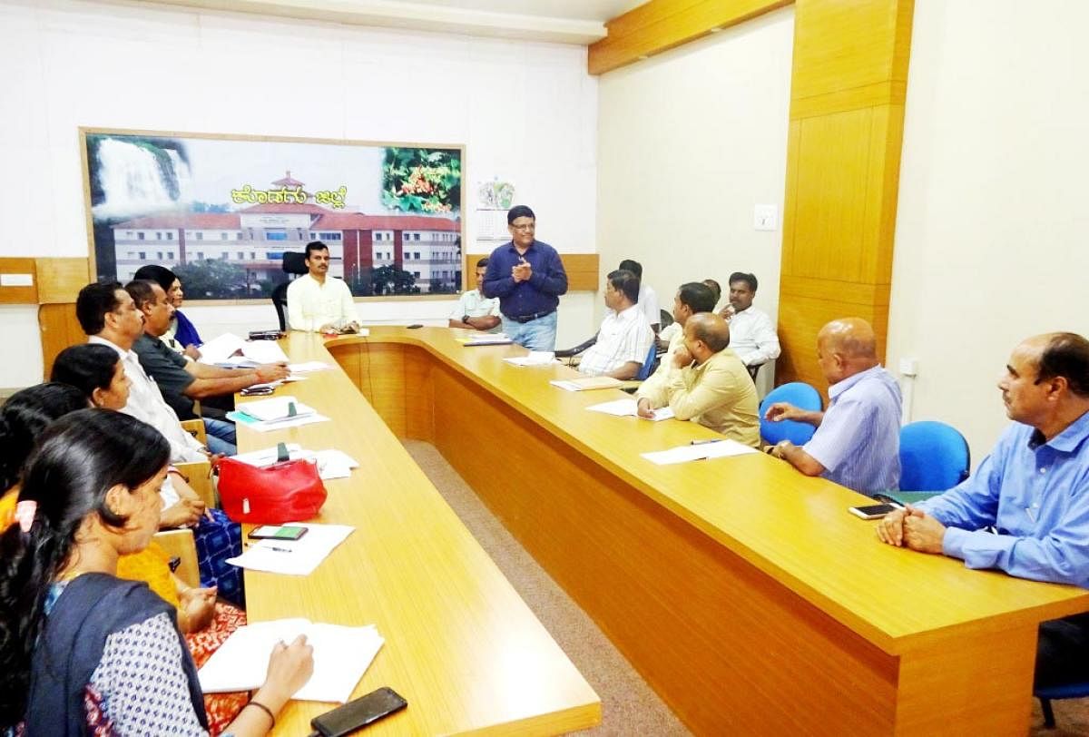 Officials take part in a meeting in Madikeri.