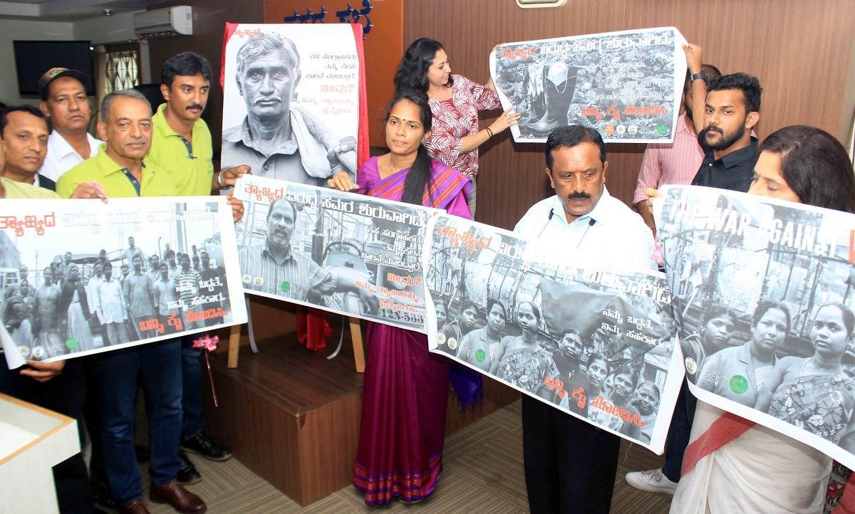 Kodagu Deputy Commissioner Annies Kanmani Joy and other dignitaries release the poster on scientific waste management in Madikeri on Monday.
