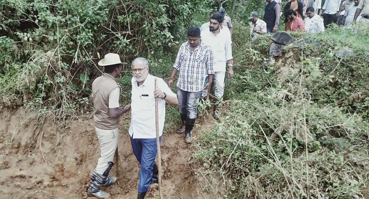 Minister S Suresh Kumar visits the place of landslide in Thora, Kodagu district, on Thursday.