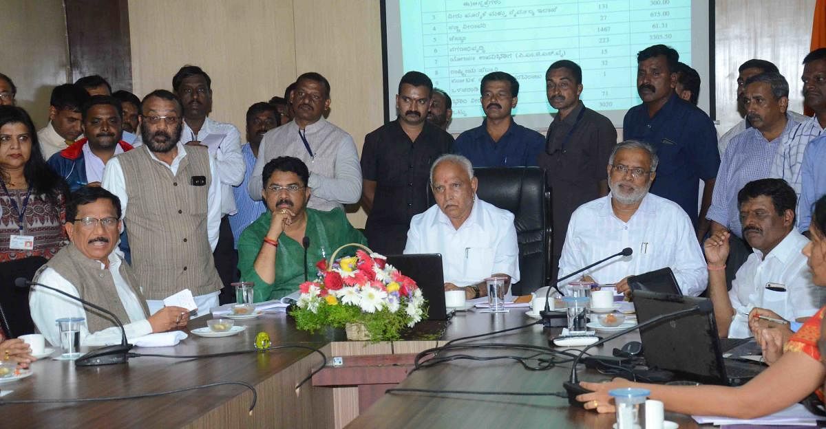 Chief Minister B S Yediyurappa conducts a review meeting in Sainik School, Koodige, on Thursday. Revenue Minister R Ashoka, District In-charge and  Primary and Secondary Education Minister Suresh Kumar, MLAs K G Bopaiah and Appachu Ranjan look on. 