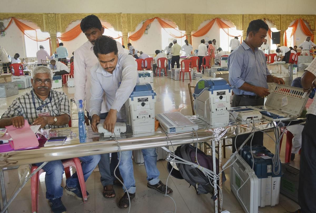 Polling officials check Electronic Voting Machines (EVM)'s and VVPAT's ahead of Maharashtra Assembly elections, in Karad, Maharashtra. (PTI Photo)