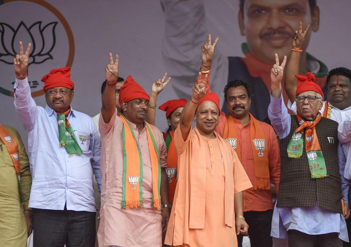Chief minister of Uttar Pradesh Yogi Adityanath waves at his supporters during an election campaign rally ahead of Maharashtra assembly polls, at Malad in Mumbai, Saturday, Oct. 19, 2019. (PTI Photo)