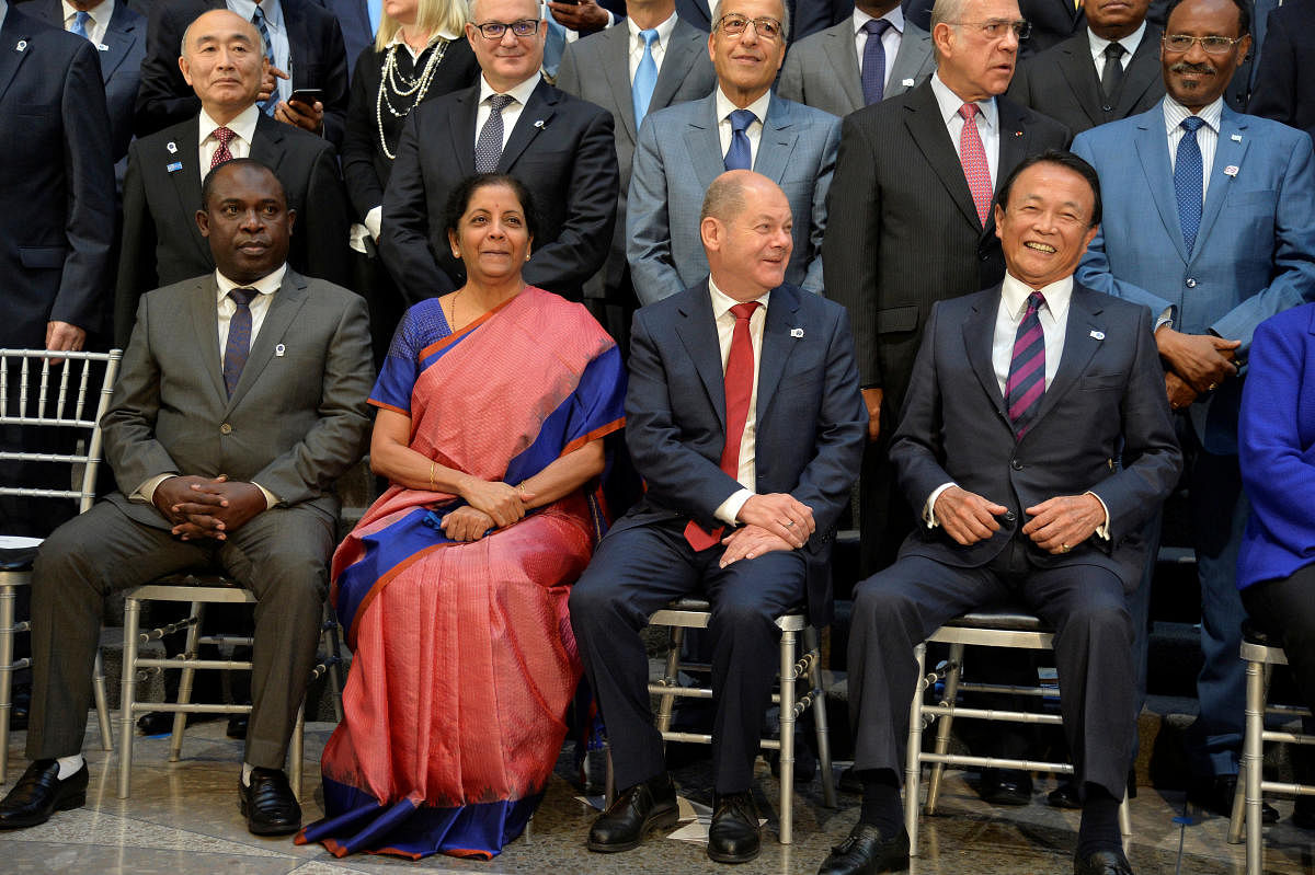 Cormoros' Finance Minister Said Ali Chayhane, India's Finance Minister Nirmala Sitharaman, Germany's Finance Minister Olaf Scholz and Japan's Finance Minister Taro Aso prepare for a group photo during the IMF and World Bank's 2019 Annual Meetings of finan