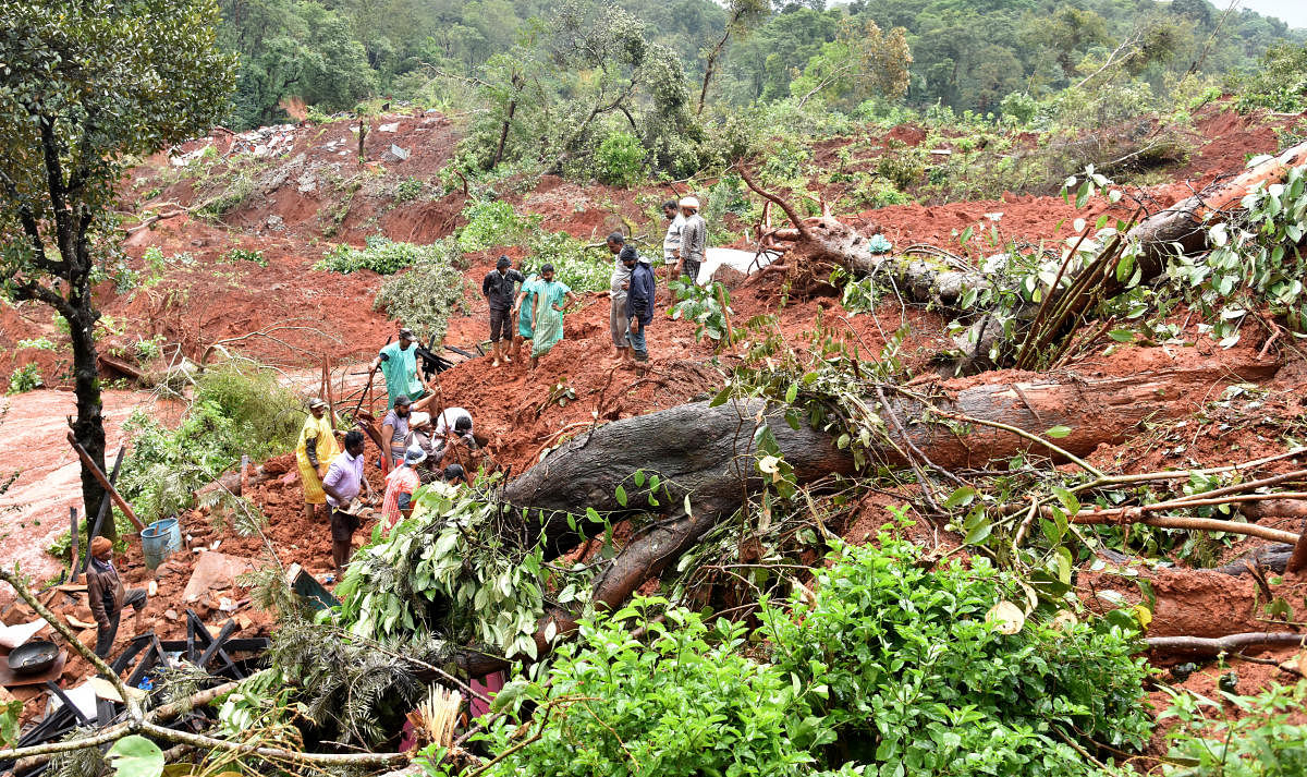People searching the site of a landslide at Hatti Hole in Kodagu  district where a body was found on Wednesday. DH PHOTO/B H SHIVAKUMAR