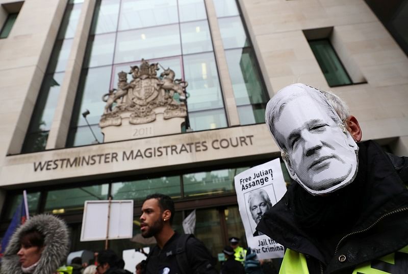 Demonstrators hold banners during a protest outside of Westminster Magistrates Court, where a case management hearing in the U.S. extradition case of WikiLeaks founder Julian Assange is held, in London, Britain. (Reuters Photo)