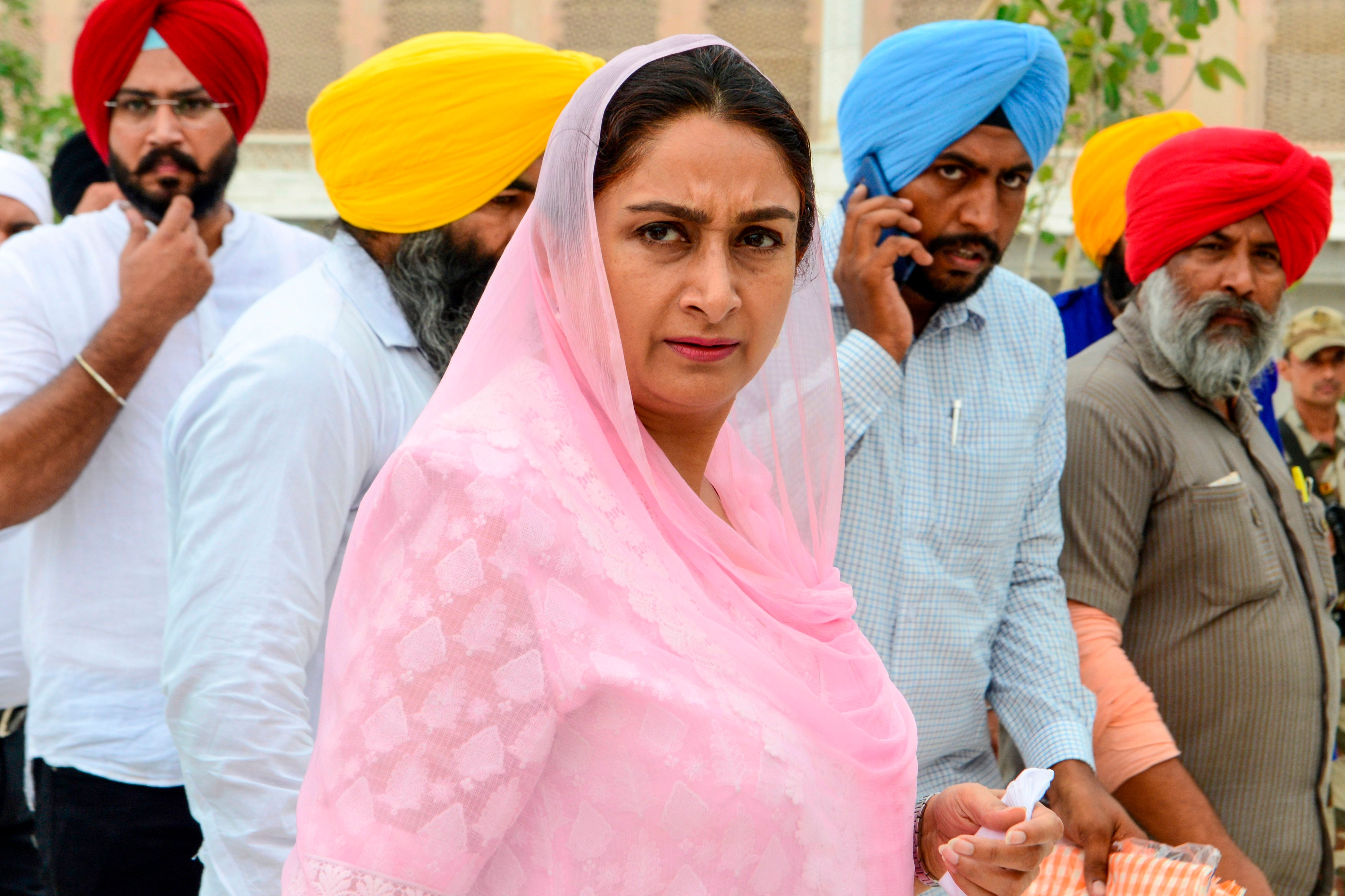 Union Cabinet Minister of Food Processing, Harsimrat Kaur Badal (C), pays her respect at the Golden Temple in Amritsar. (PTI Photo)