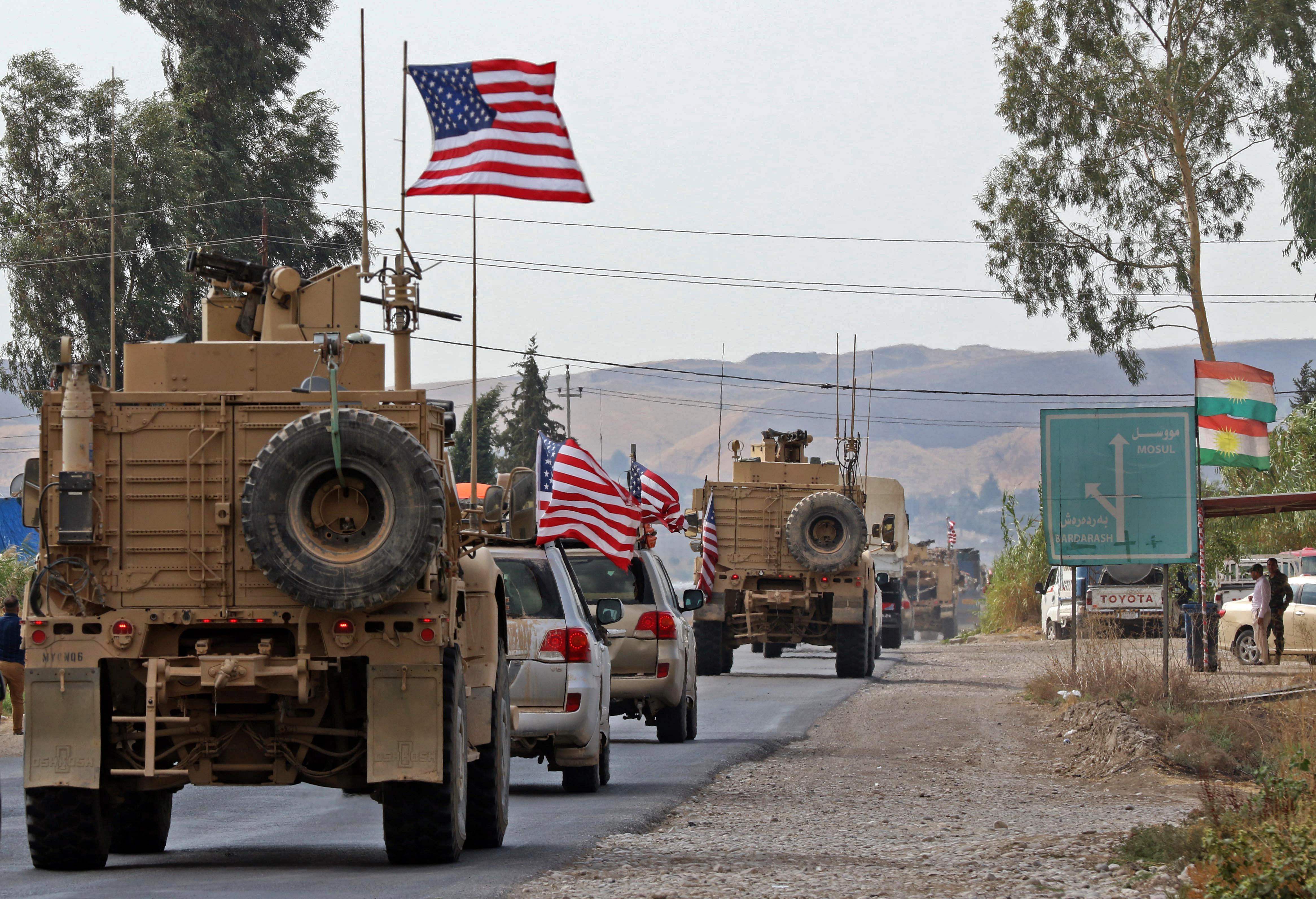 A convoy of US military vehicles arrives near the Iraqi Kurdish town of Bardarash in the Dohuk governorate after withdrawing from northern Syria. (AFPP Photo)