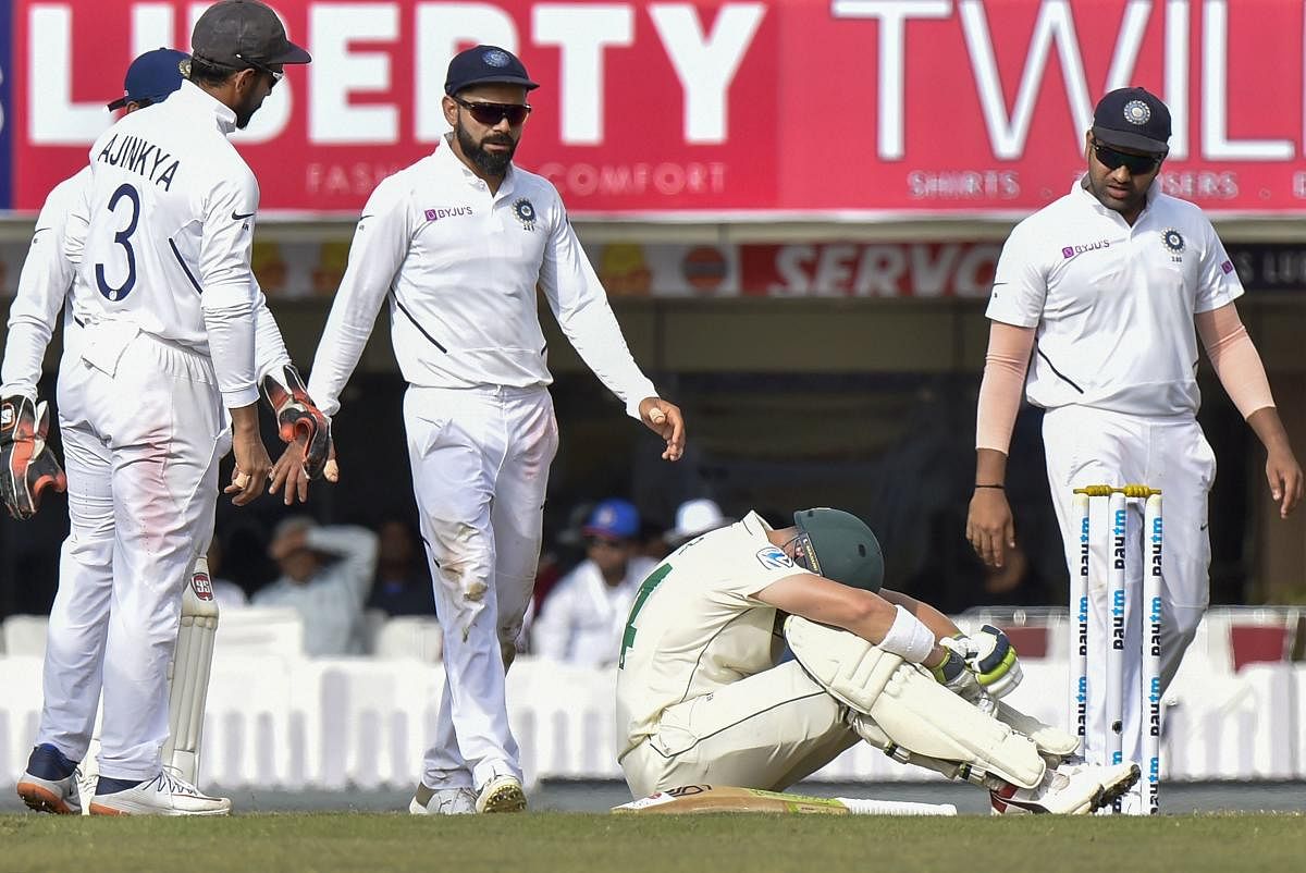 Indian skipper Virat Kohli and other players walk towards South African cricketer Dean Elgar after he got injured during day 3 of the 3rd cricket test match at JSCA Stadium in Ranchi, Monday, Oct. 21, 2019. (PTI Photo/Ashok Bhaumik)