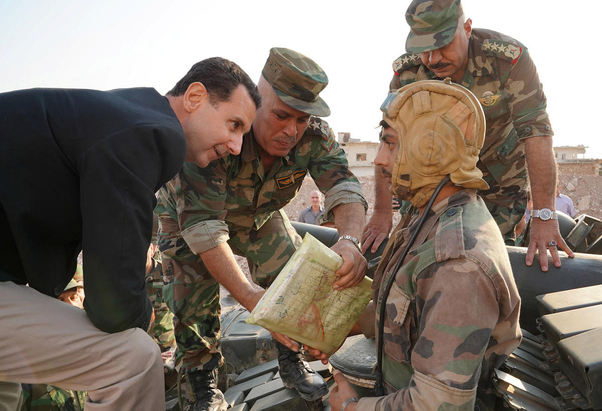 Syrian President Bashar al Assad visits Syrian army troops in war-torn northwestern Idlib province, Syria, in this handout released by SANA. Reuters/SANA