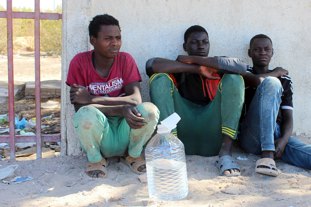 Migrants are seen on the street, after being rescued by the Libyan coast guard, in Misrata, Libya. Reuters