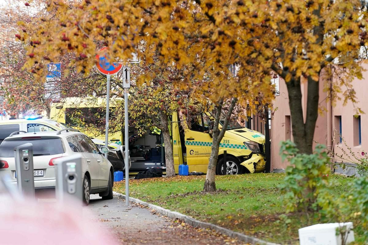 A stolen ambulance car that crashed against a house is pictured on October 22, 2019 in Oslo, Norway. - Norwegian police arrested an armed man who, according to media reports, went on the rampage in Oslo inthe stolen ambulance, running down pedestrians including a baby in a pram. AFP