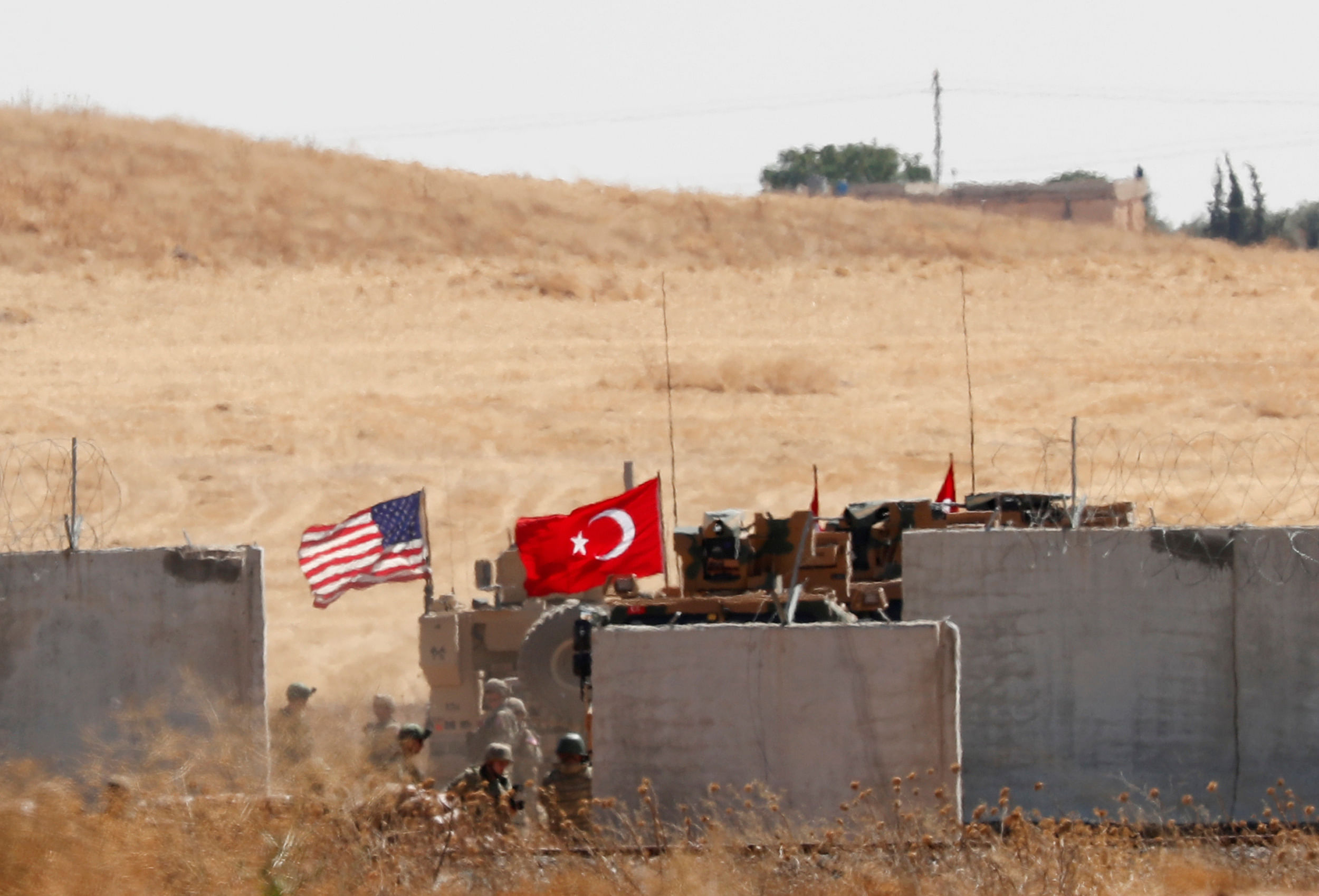 Turkish and U.S. troops return from a joint U.S.-Turkey patrol in northern Syria, as it is pictured from near the Turkish town of Akcakale, Turkey. (Reuters Photo)