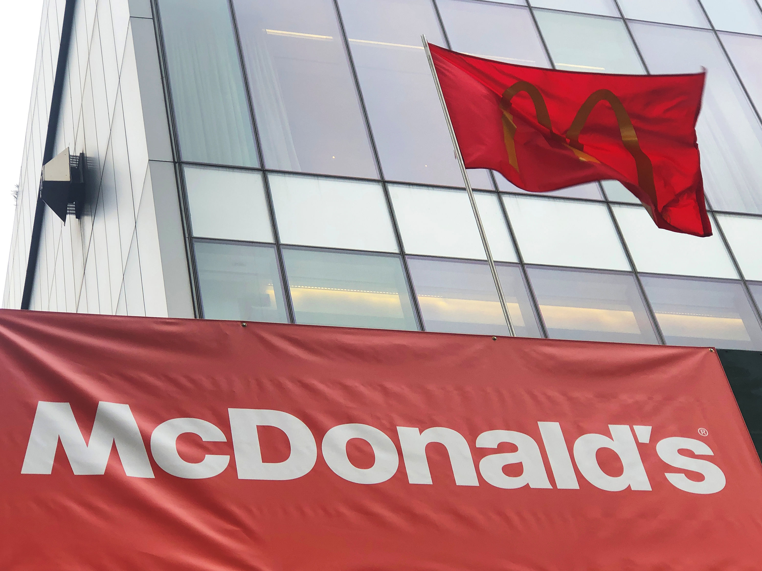 A McDonald's banner and flag are seen outside the fast-food chain McDonald's in New York, US. (Reuters Photo)