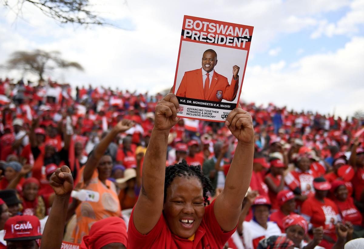 A Botswana Democratic Party (BDP) supporter holds up a poster during an election campaign rally in Mokgweetsi Masisi's, President of Botswana and leader of the BDP, home village in Moshupa, on October 22, 2019. AFP photo