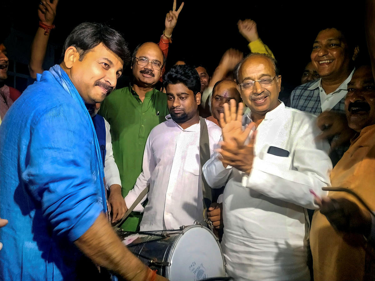 Delhi BJP President Manoj Tiwari and party MP Vijay Goel celebrate after Union Cabinet granted ownership rights to people living in unauthorised colonies in Delhi, in New Delhi on Wednesday. (PTI Photo)
