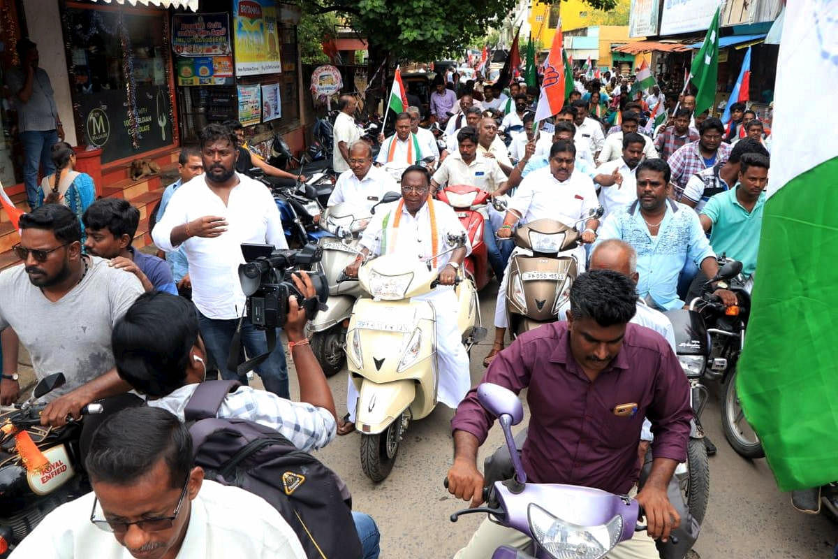 File PTI photo Puducherry Chief Minister V Narayanasamy (C) leads a two-wheeler rally in support of Congress by-poll candidate from Kamaraj Nagar legislative