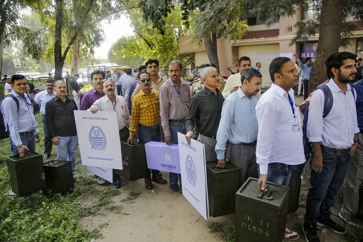  Polling officials carry ballot boxes and election material before leaving for the polling stations on the eve of Block Development Councils (BDC) elections, in Jammu, Wednesday, Oct. 23, 2019. (PTI Photo)