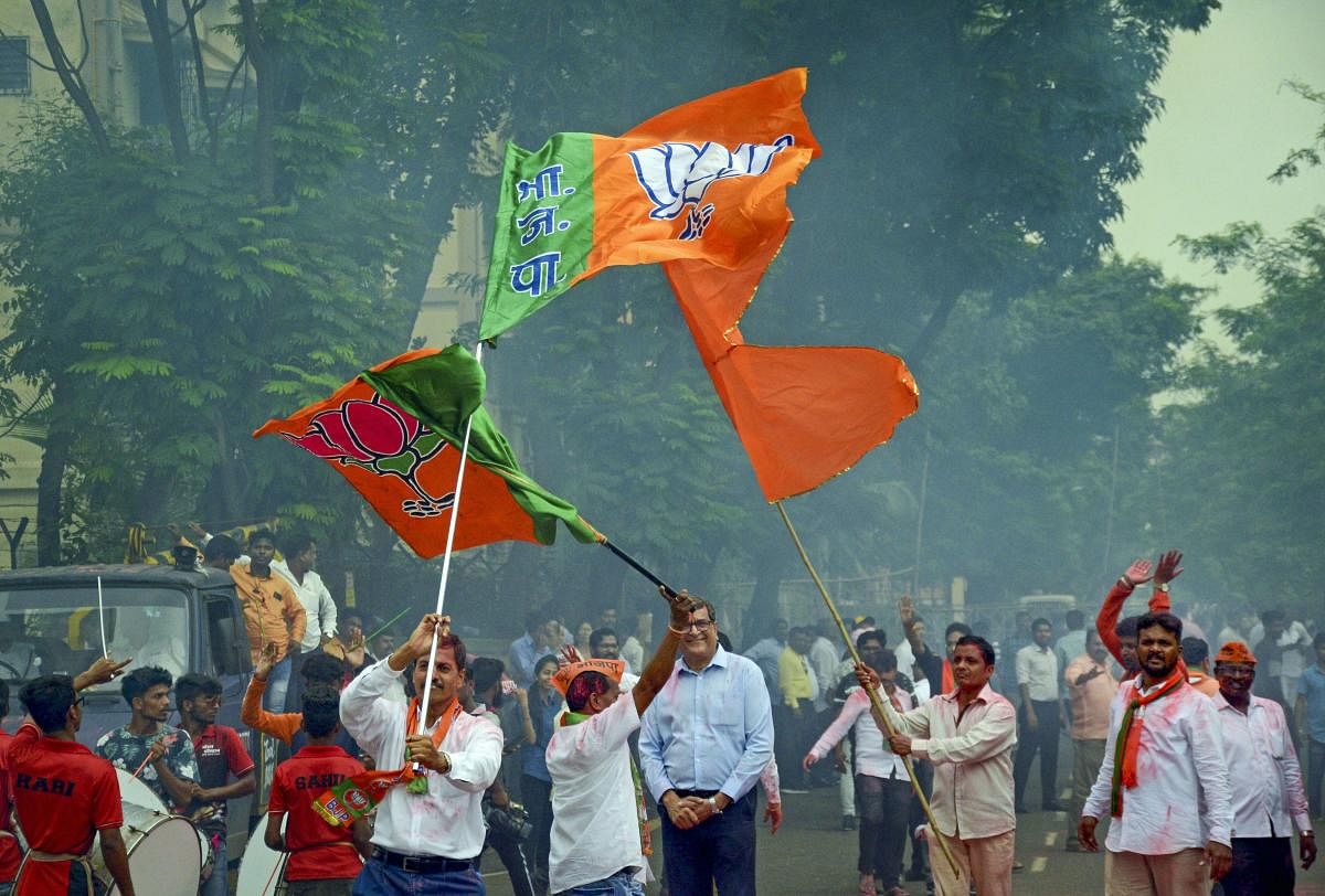 BJP and Shiv Sena workers celebrate their victory in Maharashtra Assembly elections at Agri Koli Bhavan, Nerul, in Navi Mumbai, Thursday, Oct. 24, 2019. (PTI Photo)