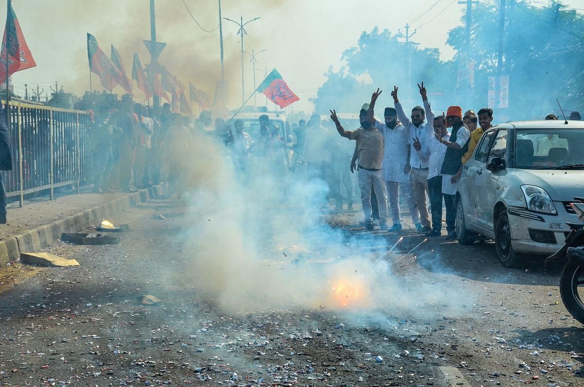 BJP supporters burn crackers to celebrate the victory of the party candidate from Kanpur Assembly seat, Surendra Maithani at Govind Nagar in Kanpur, Thursday, Oct. 24, 2019. (PTI Photo)