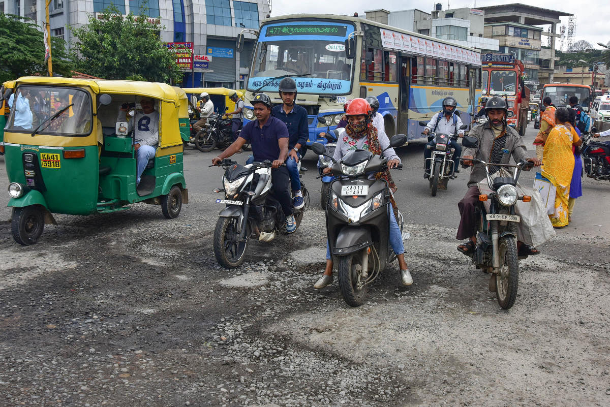 Potholes on Mysuru Road at Nayandahalli Circle (left) and near Bapuji Nagar Cross (above). DH PHOTOs/IRSHAD MAHAMMAD