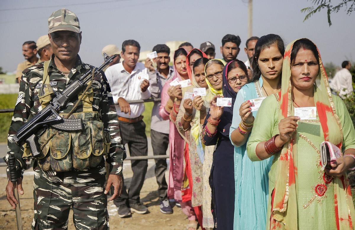 Panches and Sarpanches stand in a queue to cast their votes for Block Development Councils (BDCs) elections in Jammu (PTI Photo)