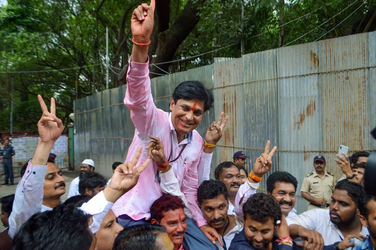 Chetan Tupe, NCP wining candidate from Hadapsar constitiency gestures at an election vote counting centre in Pune, Thursday, Oct. 24, 2019. (PTI Photo)